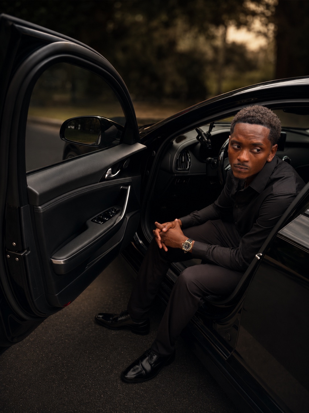 Dirk Williams Jr., owner of Lucky 8 Moving, stepping out of a black car